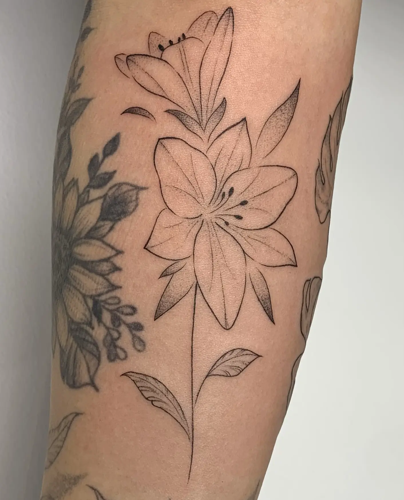 Fine-line tattoo design with delicate detail and clean single-needle style