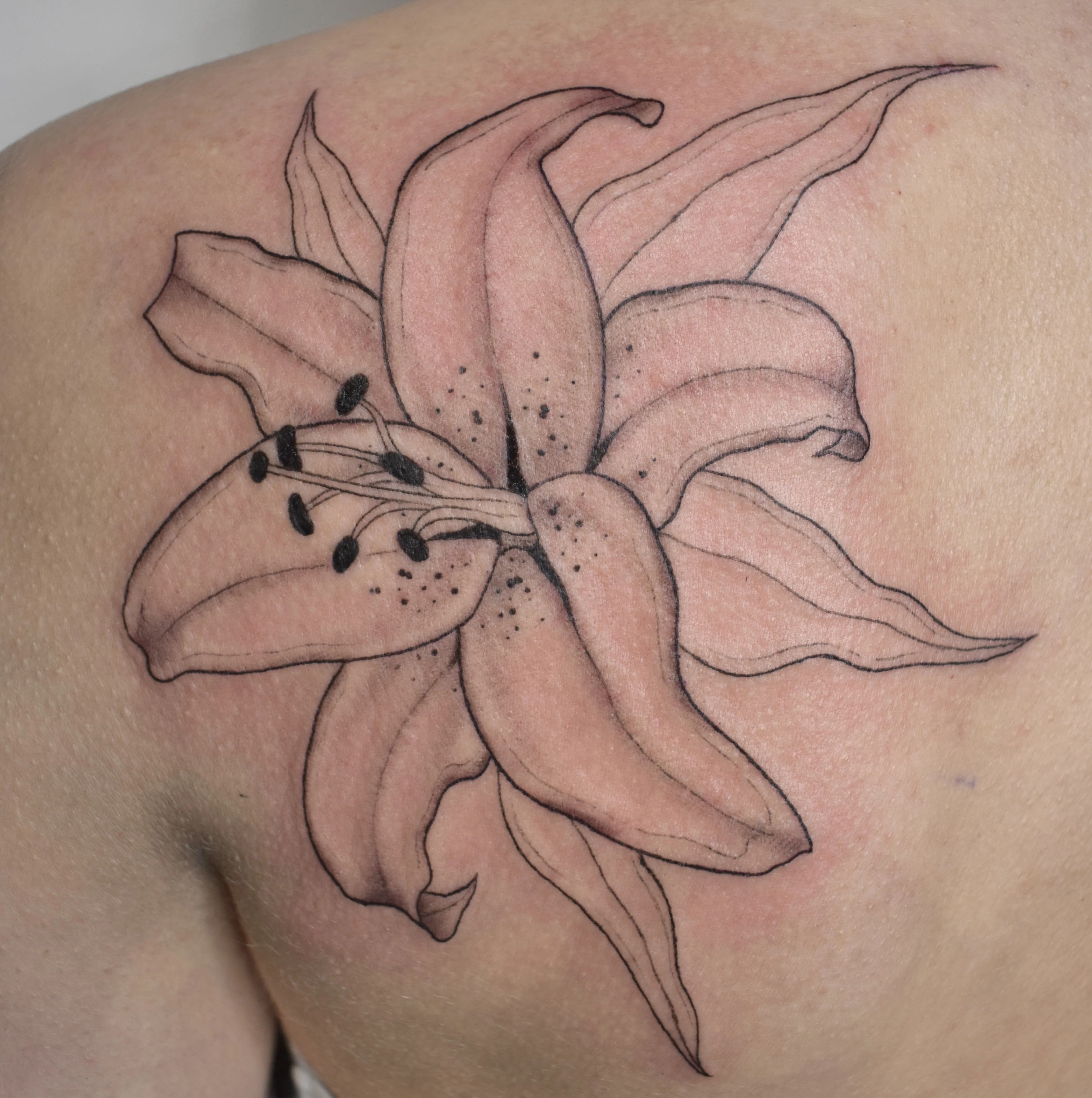Nature-inspired flower tattoo composition with elegant black and gray tones