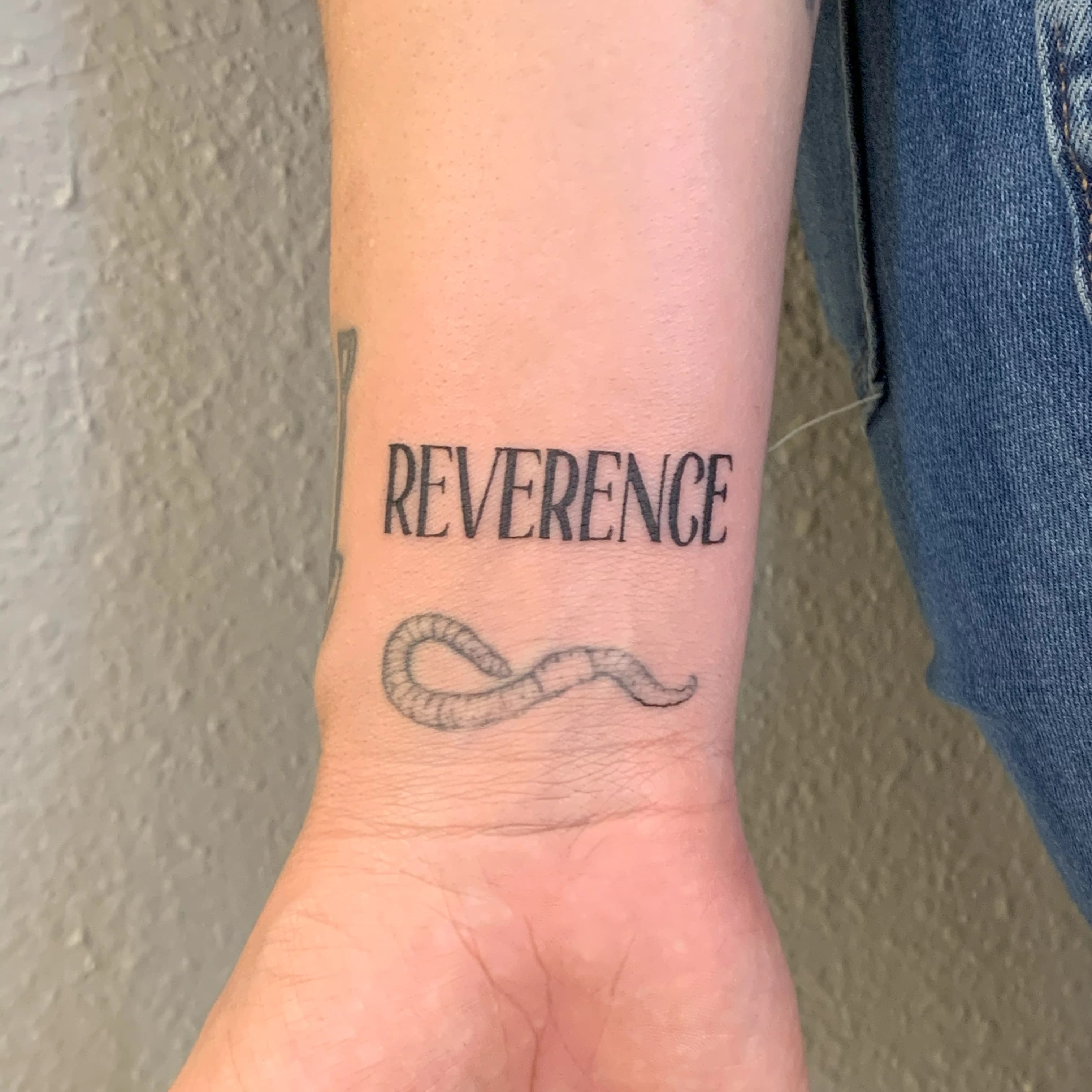 Hand-lettered tattoo piece combining decorative typography and composition